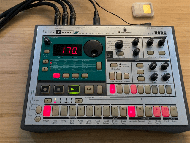 An animation of the ES-1, all plugged in, playing in pattern mode at 170 bpm, with a SmartMedia card nearby.